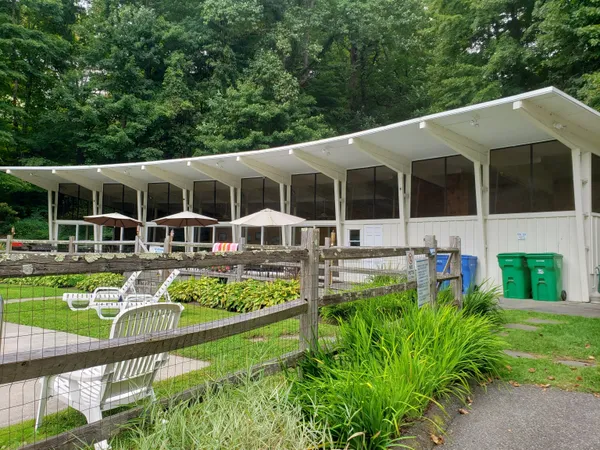 a view of a house with backyard sitting area and garden