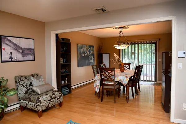 a view of a dining room with furniture and chandelier