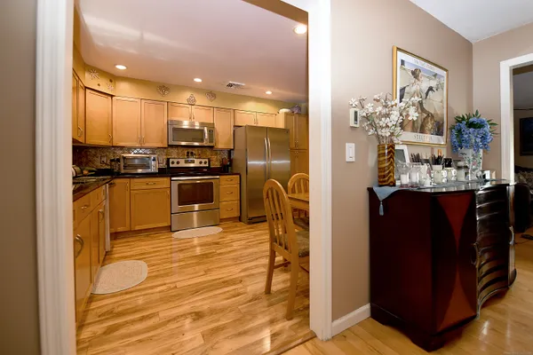 a kitchen with stainless steel appliances granite countertop a refrigerator and a stove top oven