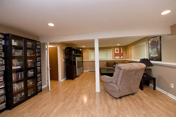 a living room with furniture and a wooden floor