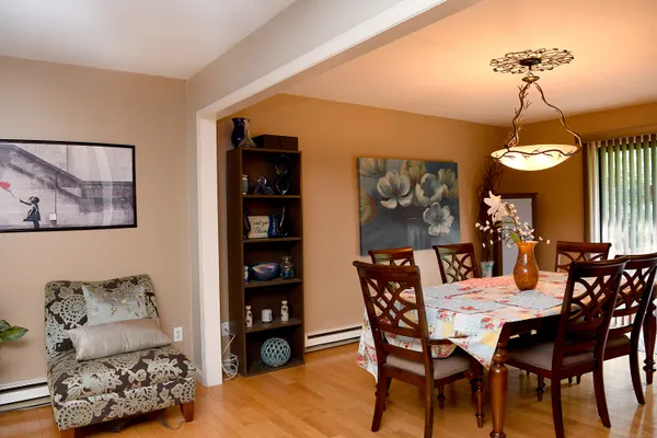 a view of a dining room with furniture and chandelier