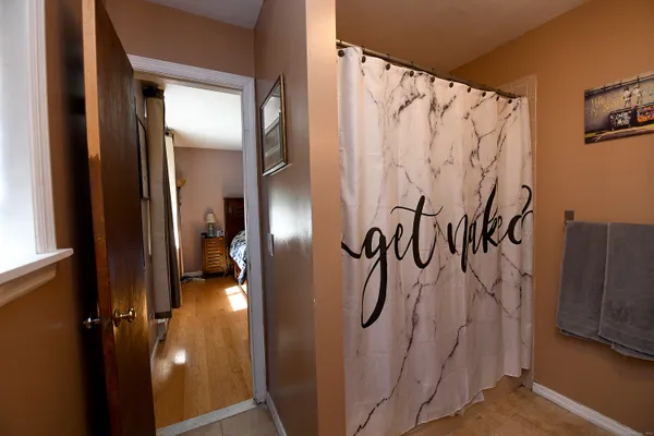 a bathroom with a shower and a mirror