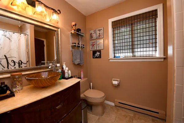 a bathroom with a double vanity sink toilet and a mirror