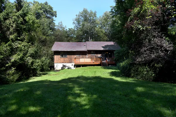 a aerial view of a house with a yard table and chairs