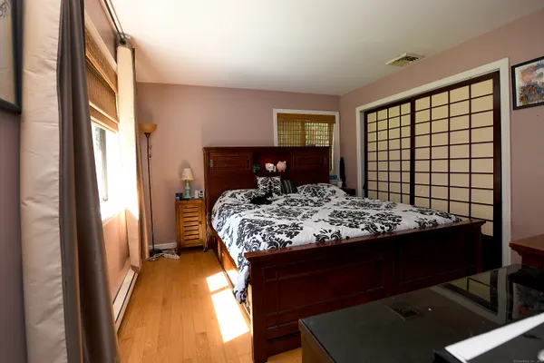 a bedroom with a bed and a window