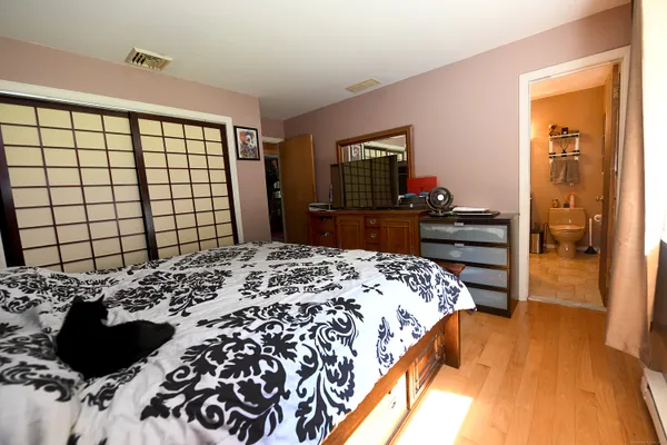 a bedroom with a bed and a dresser