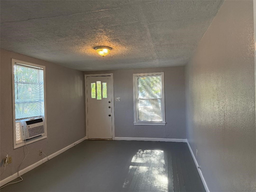 810 8th Avenue Portland, TX 78374 - Photo 3 of 16 a view of an empty room with wooden floor and a window
