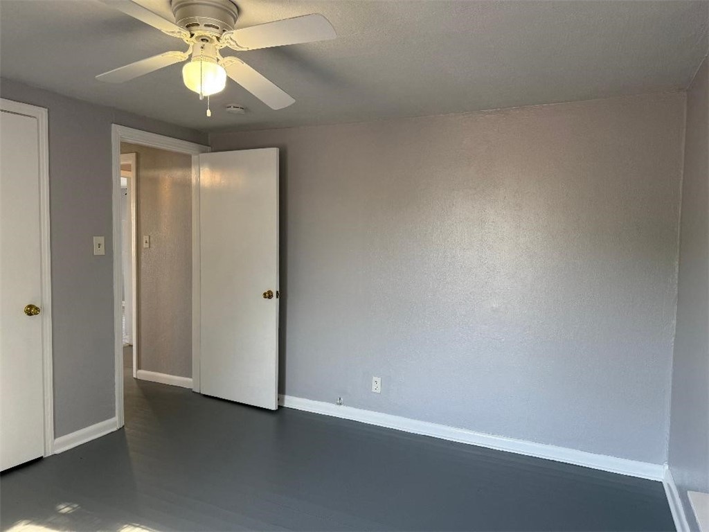 810 8th Avenue Portland, TX 78374 - Photo 10 of 16 an empty room with a chandelier fan and closet area