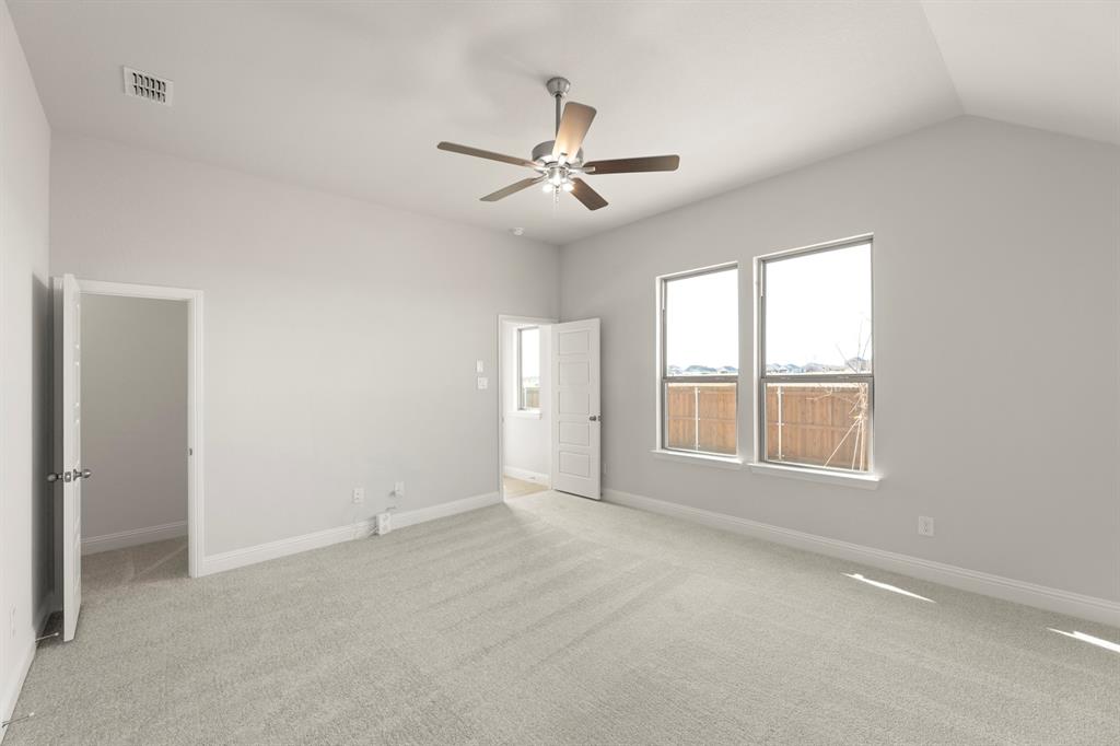 395 Misty Meadow Lane Lavon, TX 75166 - Photo 10 of 24 an empty room with chandelier fan and windows