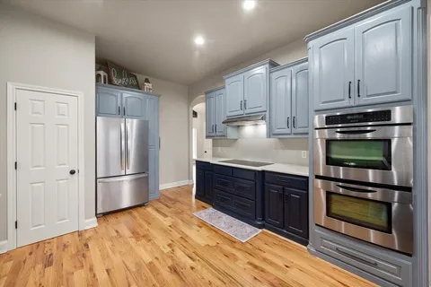 a kitchen with stainless steel appliances granite countertop a stove and a refrigerator