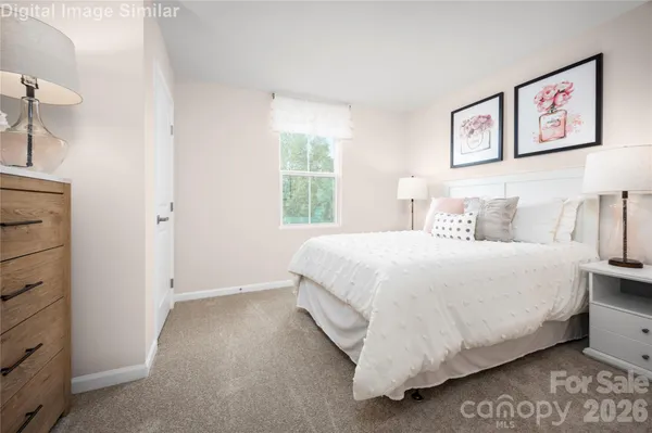 a large bed sitting in a bedroom next to a window