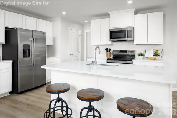 a kitchen with cabinets and stainless steel appliances