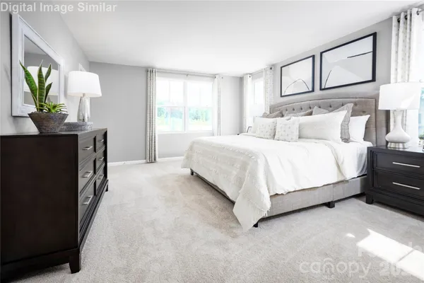 a bedroom with a bed lamps and mirror