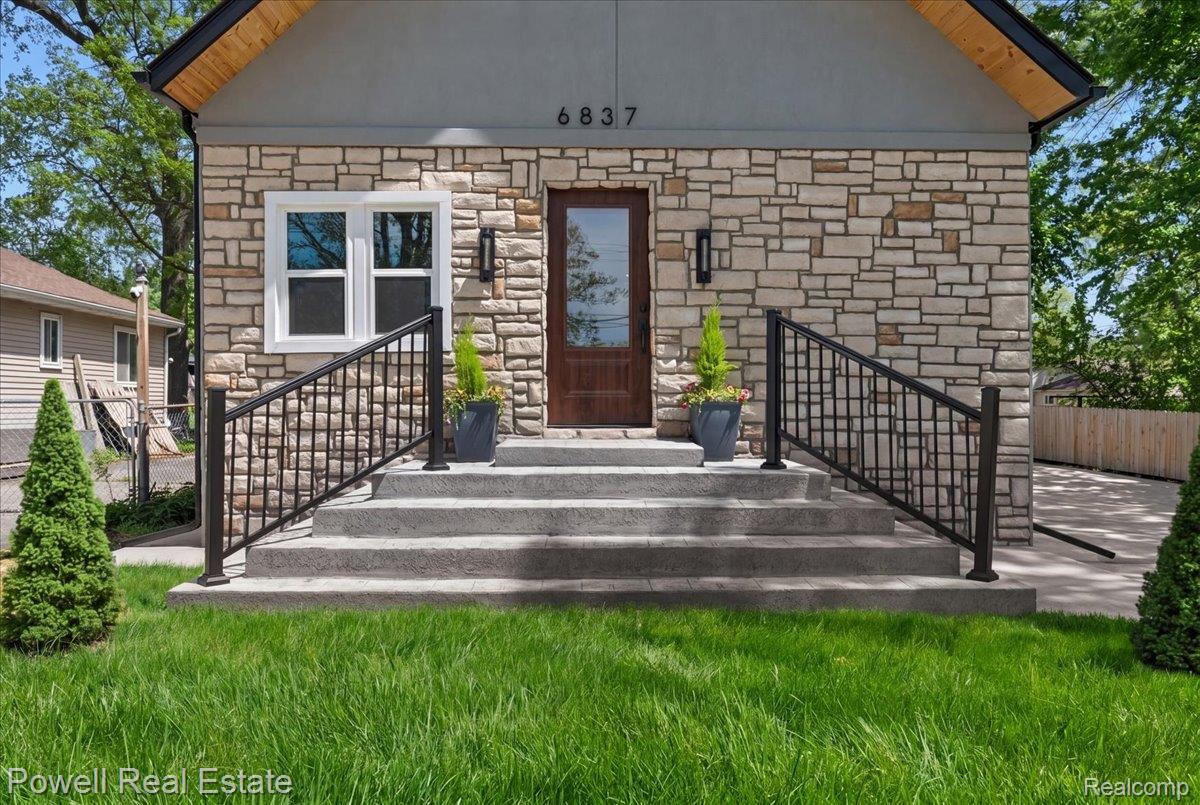 6837 Hatchery Road Waterford, MI 48327 - Photo 4 of 56 Property entrance featuring stone siding and stucco siding