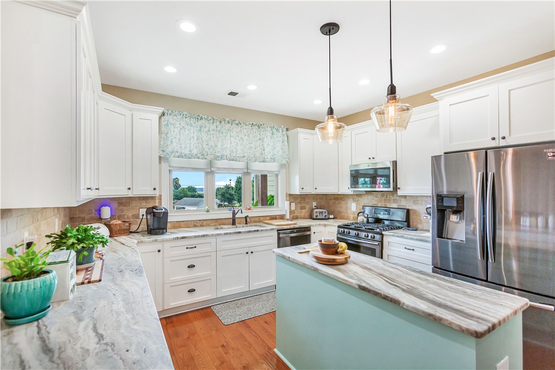 1204 Cherokee Road Townville, SC 29689 - Photo 7 of 44 A well-appointed kitchen offers bright white cabinetry, rich wood floors, and a convenient center island for culinary endeavors.