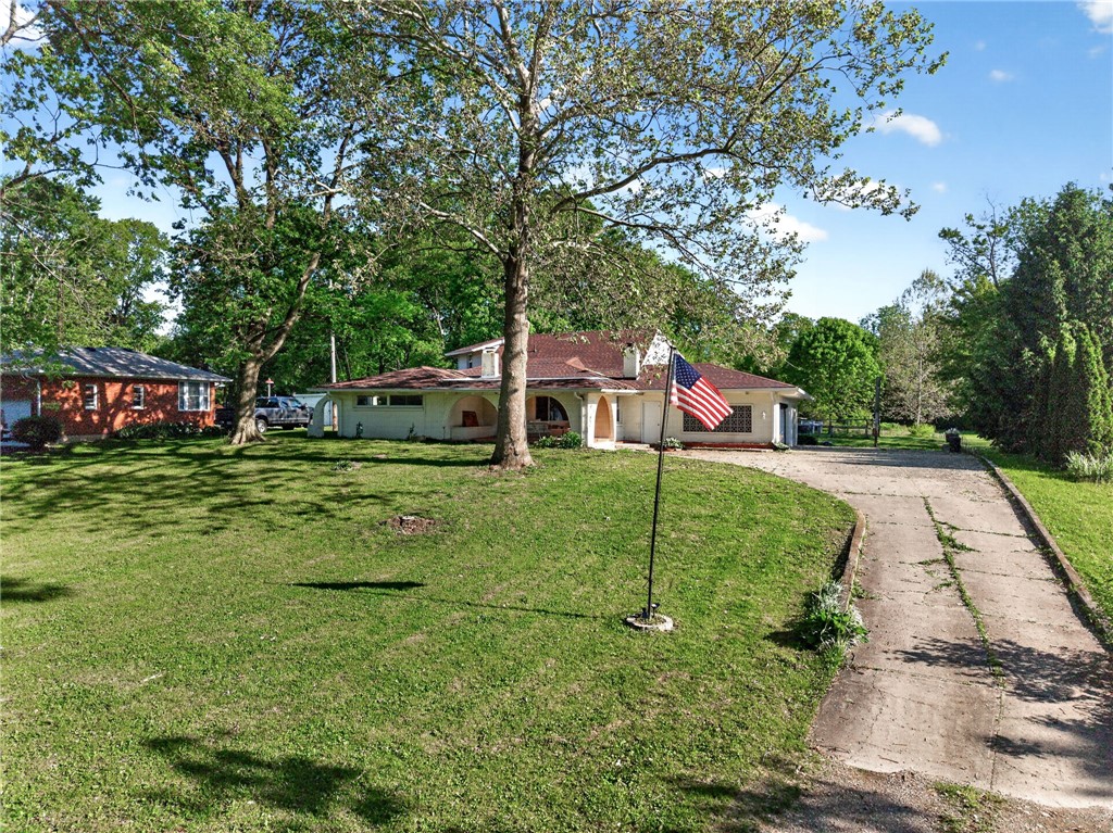 2684 Arthur Road Springfield, OH 45502 - Photo 57 of 69 This residence features a lush lawn and a welcoming driveway, offering a serene outdoor setting.
