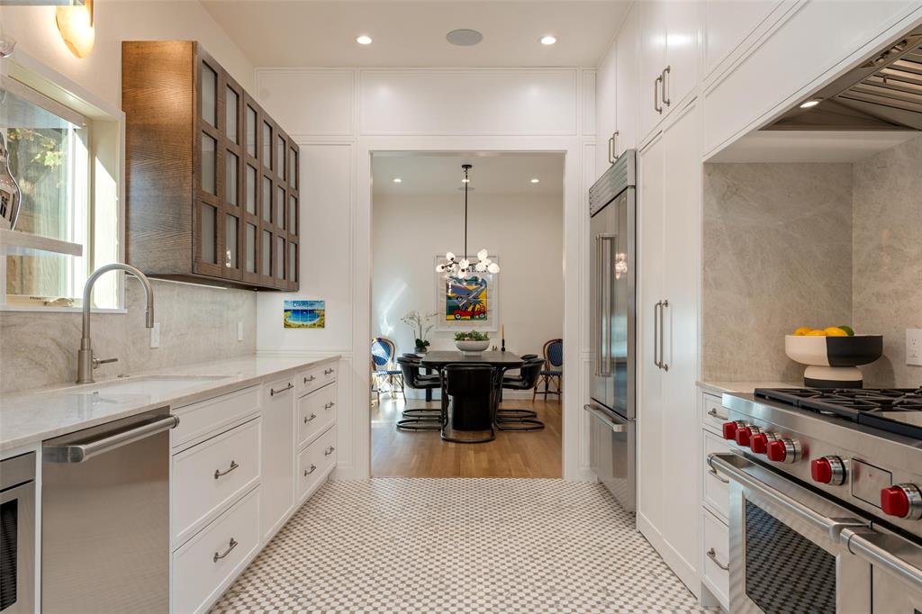 a kitchen with a refrigerator and a sink