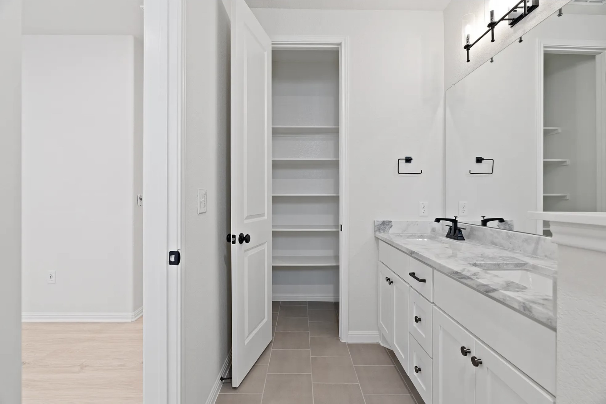 1612 Kit Circle Austin, TX 78758 - Photo 25 of 29 a bathroom with a granite countertop sink and a mirror