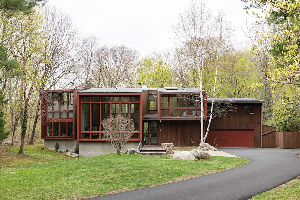 a view of a house with a yard and sitting area