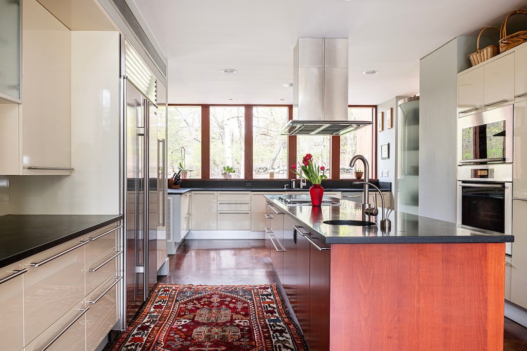 3 Barberry Road Lexington, MA 02421 - Photo 12 of 42 a kitchen with stainless steel appliances granite countertop a stove a sink and a refrigerator