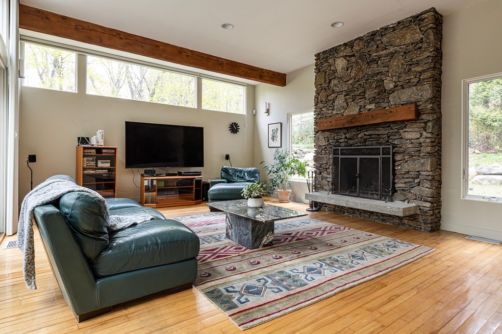 3 Barberry Road Lexington, MA 02421 - Photo 15 of 42 a living room with furniture a fireplace and a flat screen tv