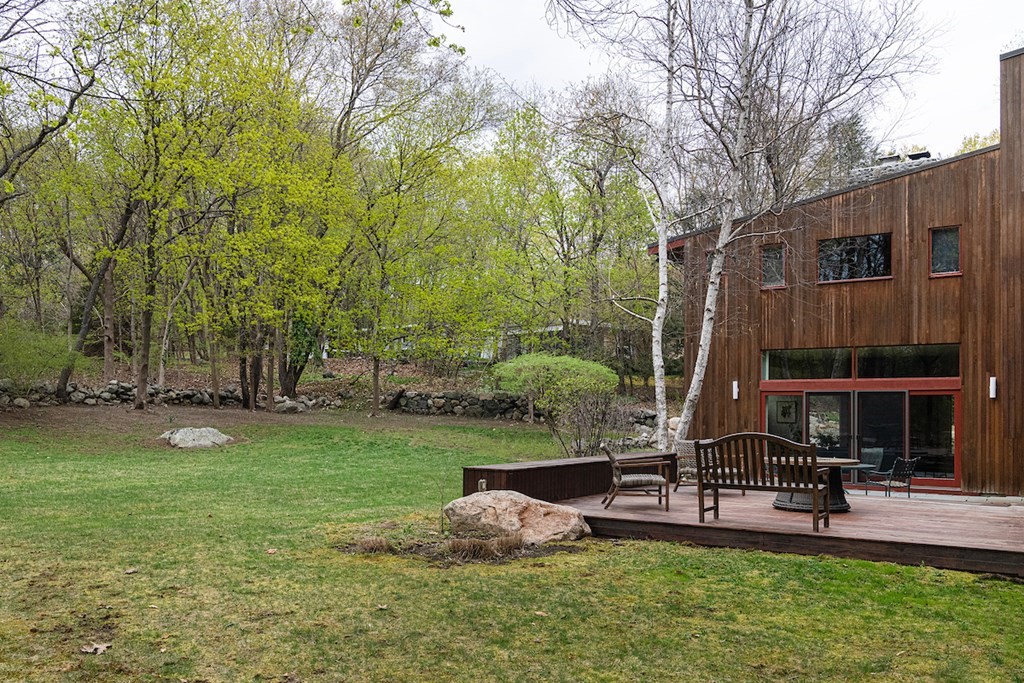 3 Barberry Road Lexington, MA 02421 - Photo 3 of 42 a view of a backyard with table and chairs and a large tree
