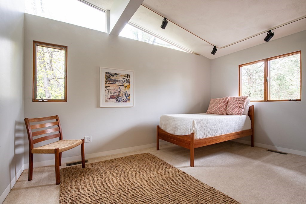 3 Barberry Road Lexington, MA 02421 - Photo 35 of 42 a bedroom with a bed lamp and a window