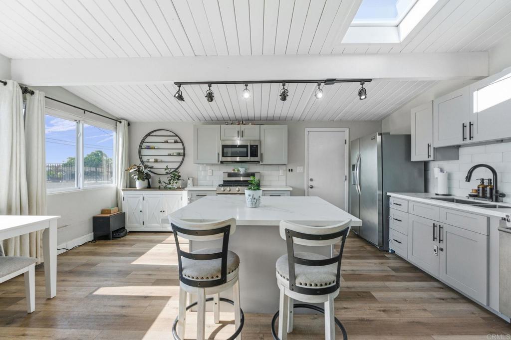 9838 Ivanho Street Spring Valley, CA 91977 - Photo 11 of 25 a large kitchen with a table and chairs