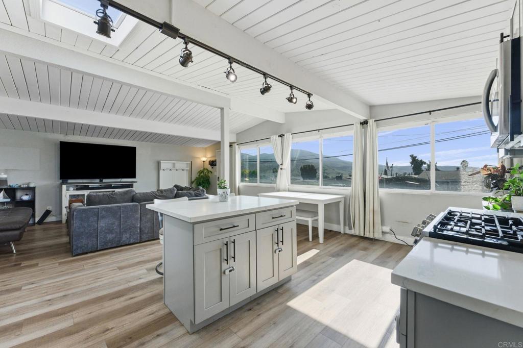 9838 Ivanho Street Spring Valley, CA 91977 - Photo 5 of 25 a kitchen with a stove a sink and a microwave
