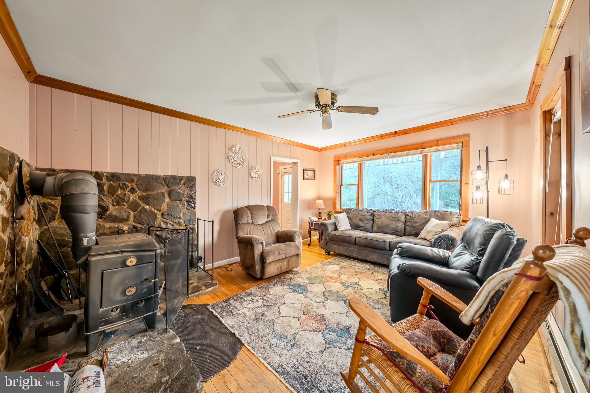 228 Huntington Creek Road Sweet Valley, PA 18656 - Photo 29 of 128 a living room with furniture ceiling fan and a rug