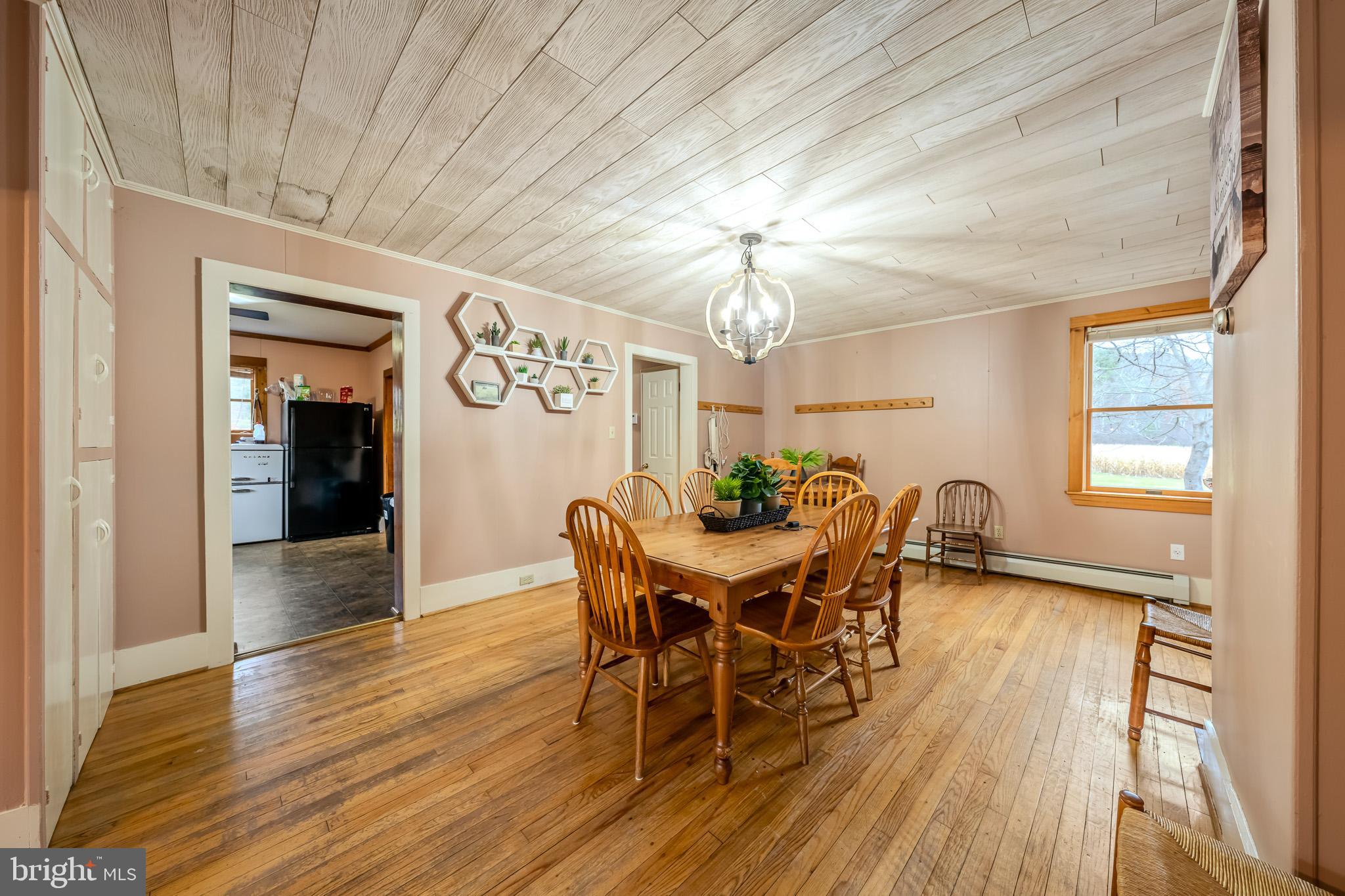 228 Huntington Creek Road Sweet Valley, PA 18656 - Photo 35 of 128 a view of a dining room with furniture a chandelier and wooden floor