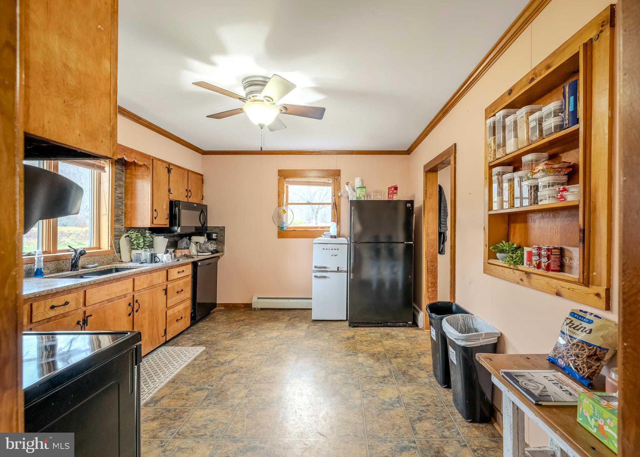 228 Huntington Creek Road Sweet Valley, PA 18656 - Photo 38 of 128 a kitchen with stainless steel appliances kitchen island granite countertop a refrigerator and a stove top oven