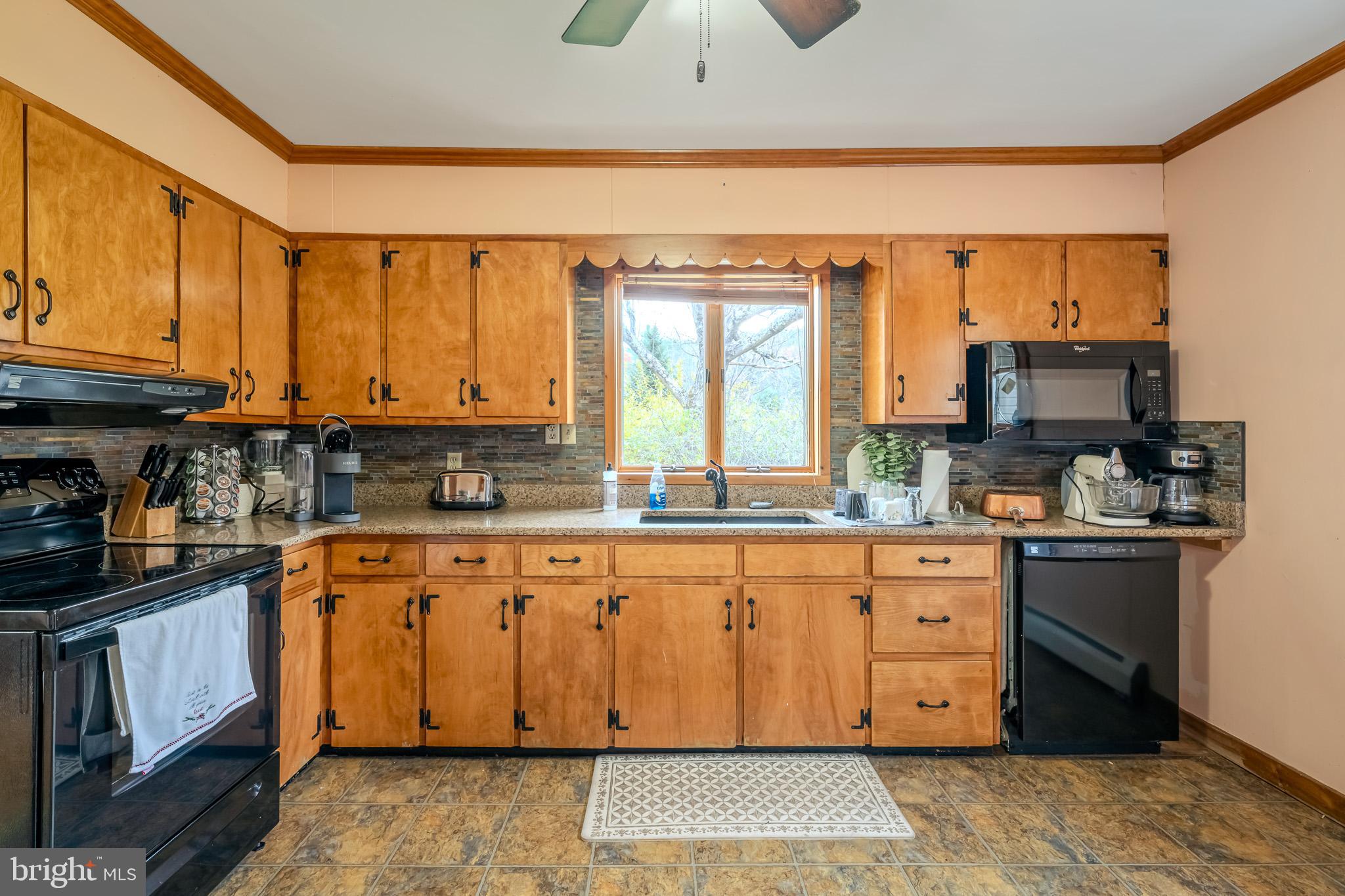 228 Huntington Creek Road Sweet Valley, PA 18656 - Photo 39 of 128 a kitchen with stainless steel appliances granite countertop a stove a sink dishwasher and a refrigerator