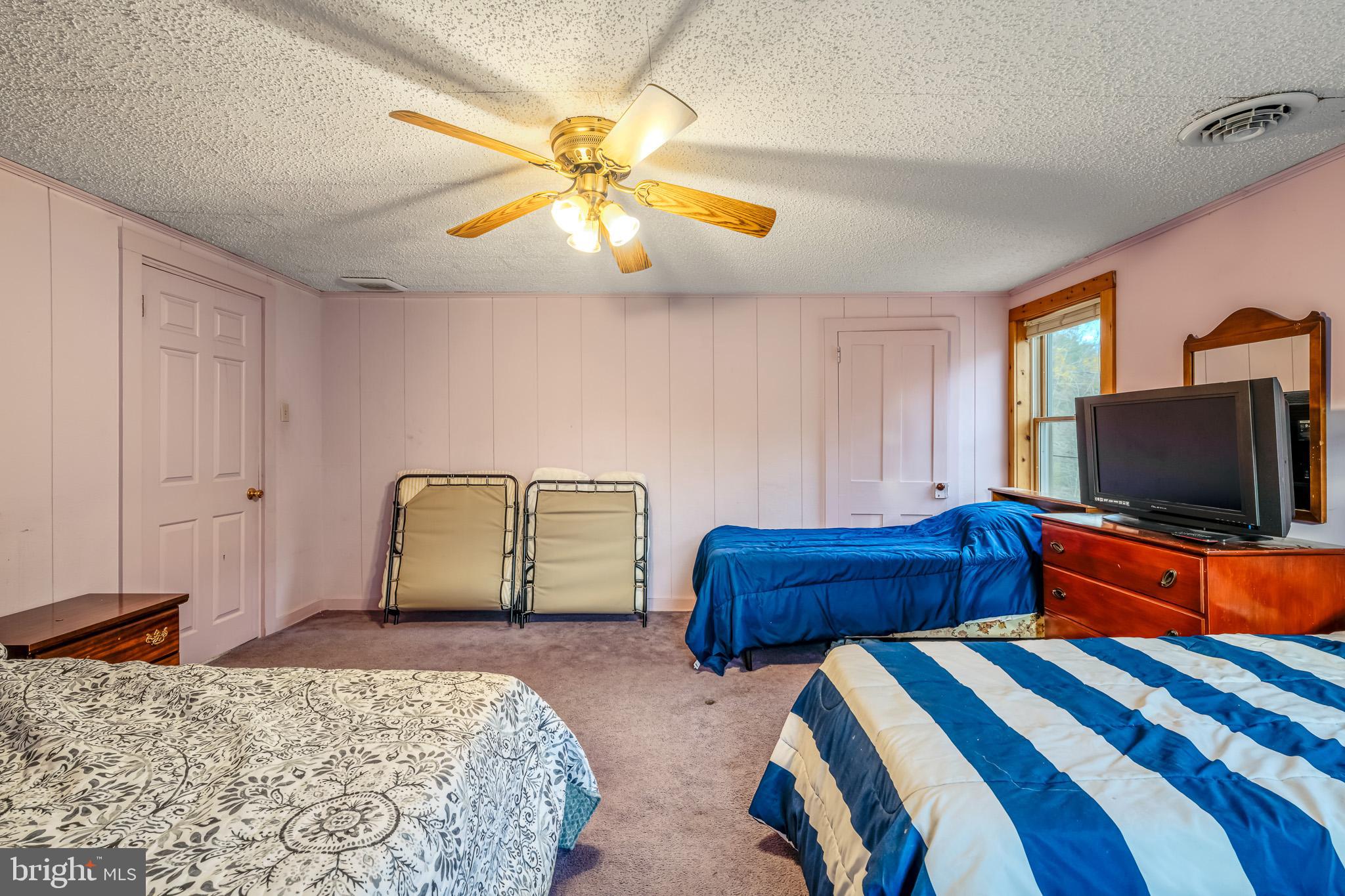 228 Huntington Creek Road Sweet Valley, PA 18656 - Photo 45 of 128 a bedroom with two beds and a flat screen tv