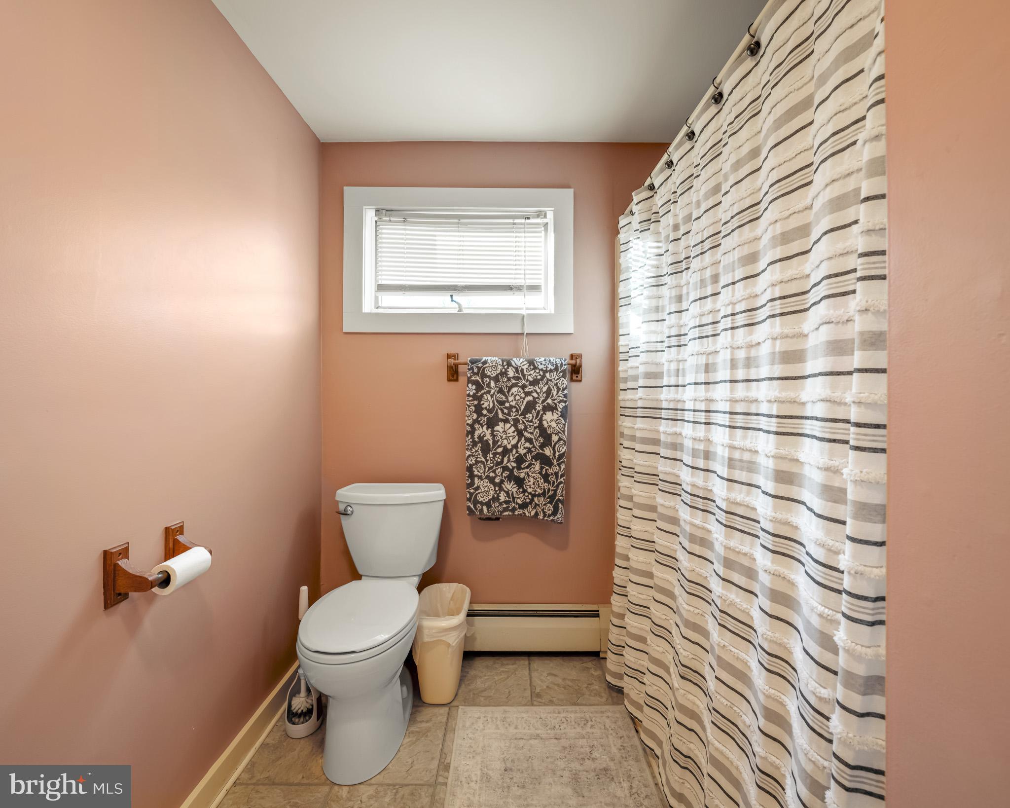 228 Huntington Creek Road Sweet Valley, PA 18656 - Photo 47 of 128 a bathroom with a toilet and a shower curtain