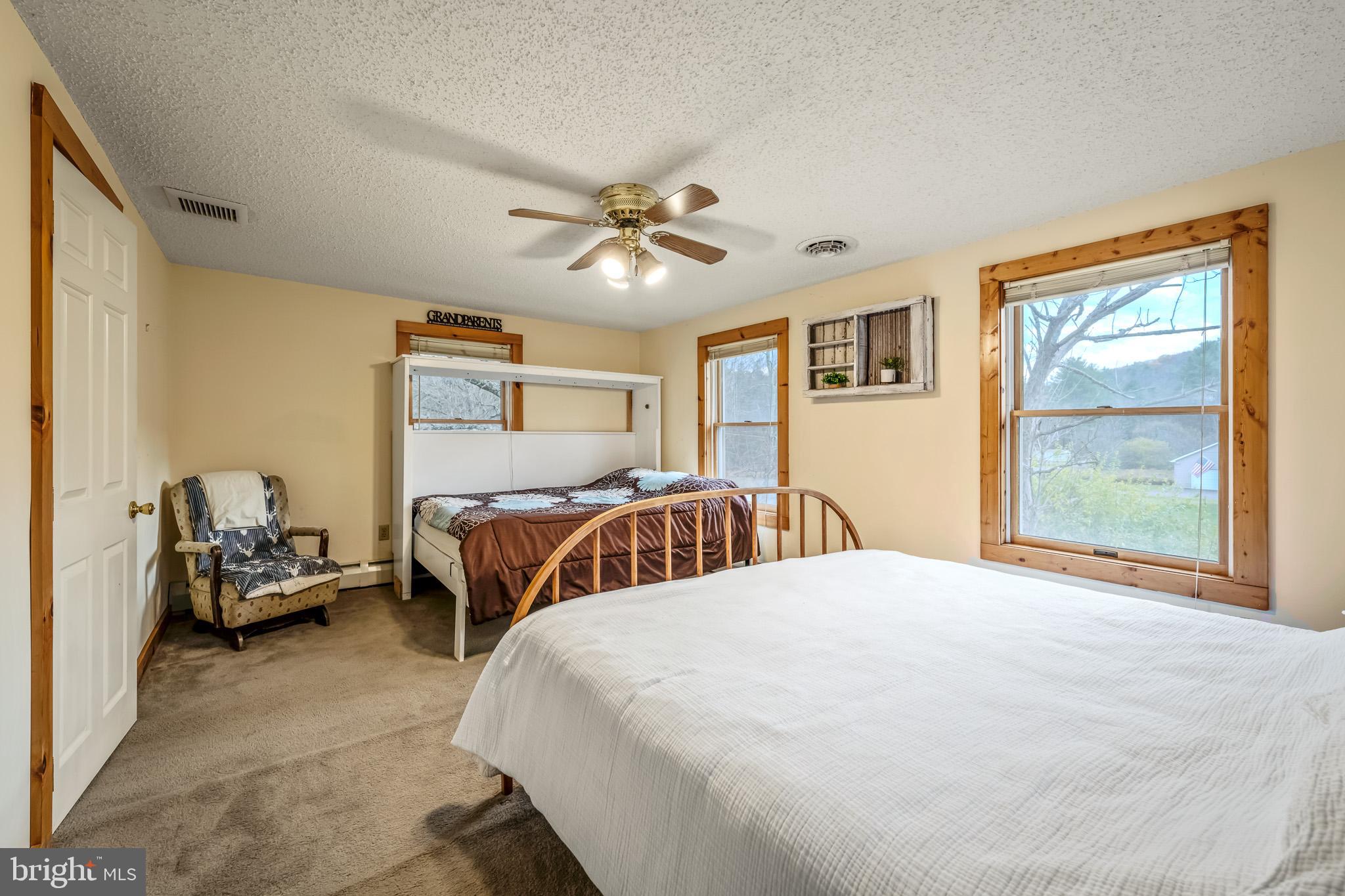 228 Huntington Creek Road Sweet Valley, PA 18656 - Photo 50 of 128 a bedroom with a bed and a chandelier