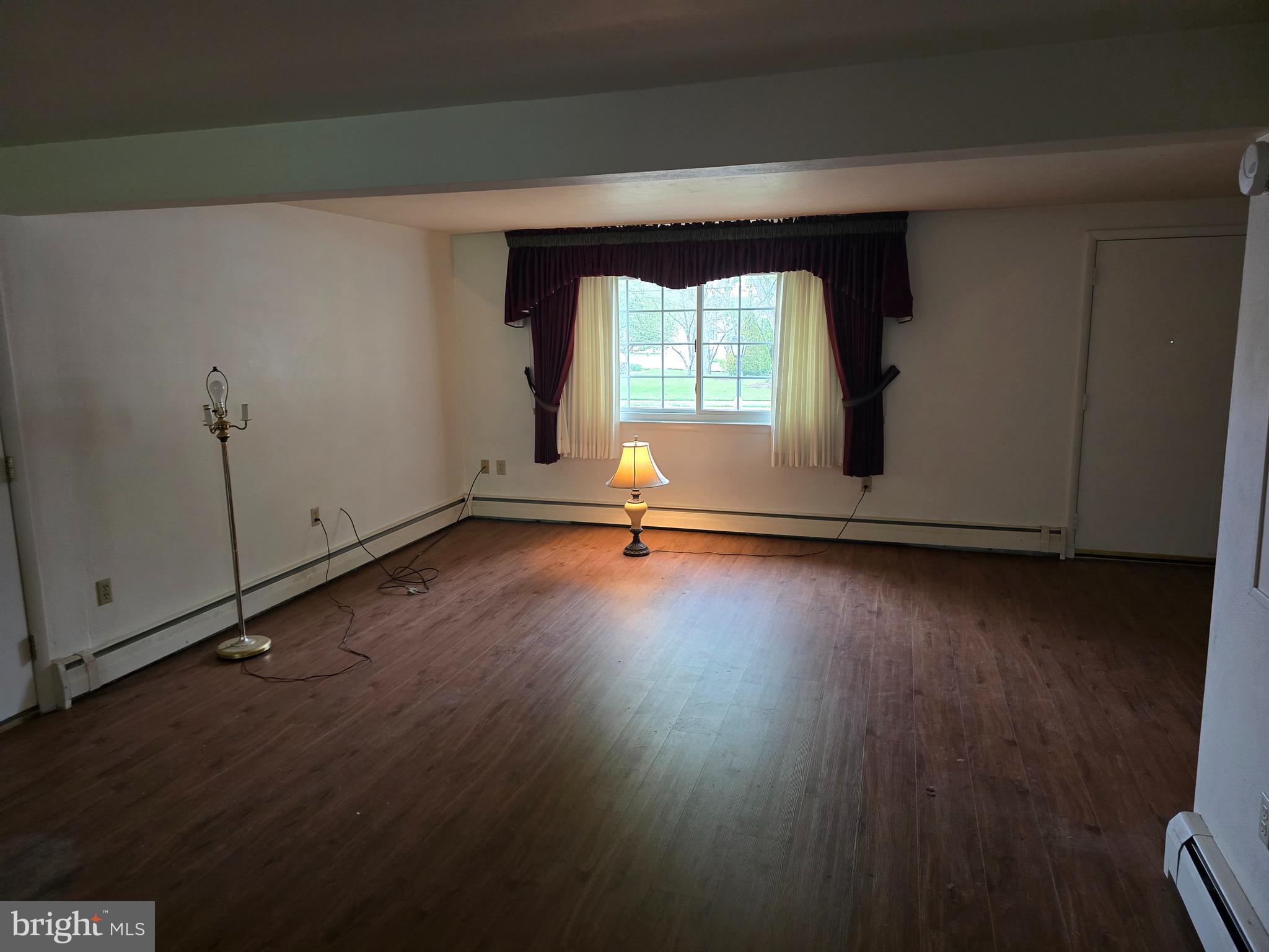 802 Sunset Avenue Gettysburg, PA 17325 - Photo 4 of 19 an empty room with wooden floor and windows