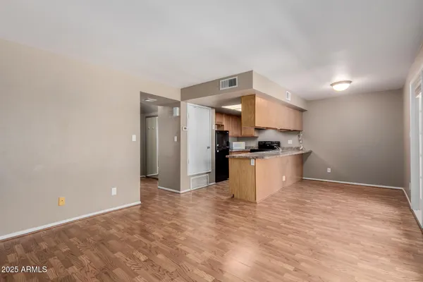 a view of kitchen with refrigerator sink and stove