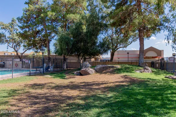 a view of yard with swimming pool and green space