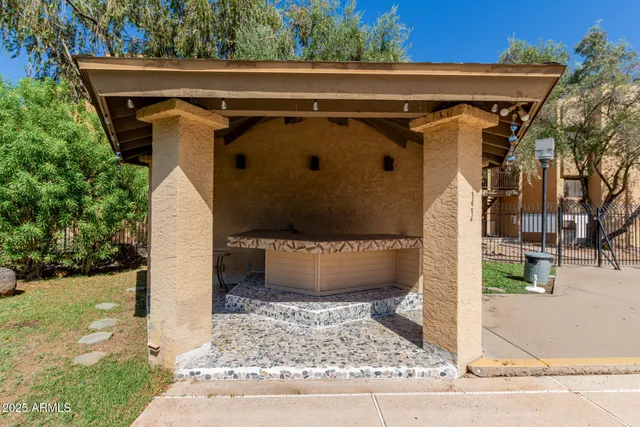 a view of a house with backyard and sitting area