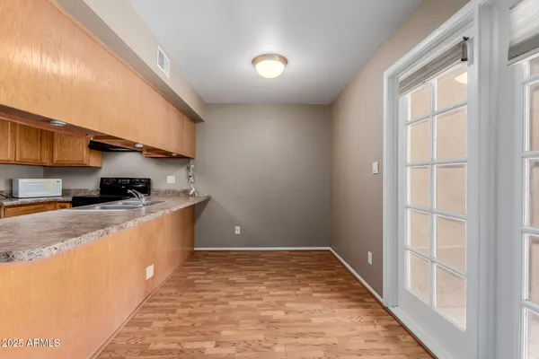 a kitchen with granite countertop a sink and a stove top oven