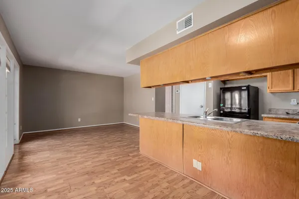 a view of a kitchen with a sink and cabinets