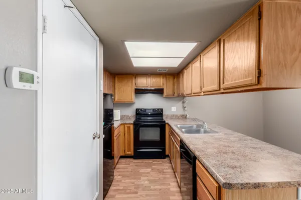 a kitchen with stainless steel appliances granite countertop a stove and a refrigerator