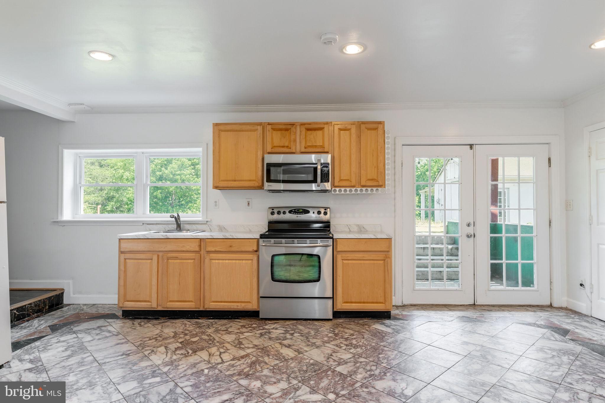 11325 Bacon Race Road Woodbridge, VA 22192 - Photo 34 of 54 a kitchen with stainless steel appliances granite countertop a stove a sink and a refrigerator