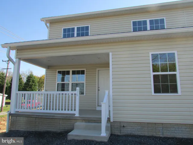 a view of a house with deck and wooden floor