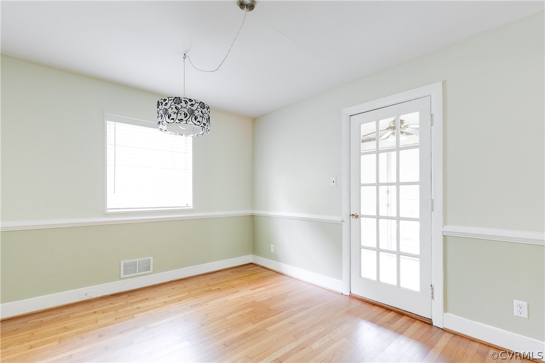 3911 Arklow Road Richmond, VA 23235 - Photo 11 of 39 an empty room with wooden floor and windows
