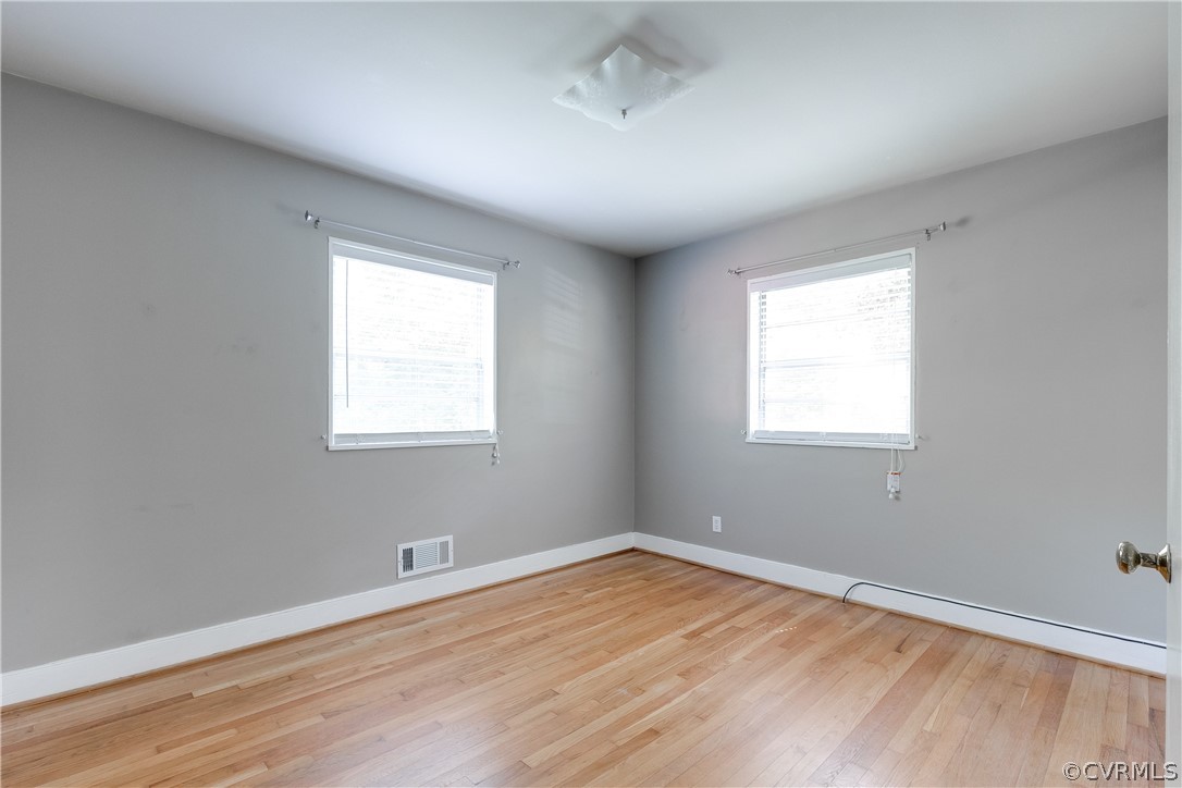3911 Arklow Road Richmond, VA 23235 - Photo 20 of 39 an empty room with wooden floor and windows