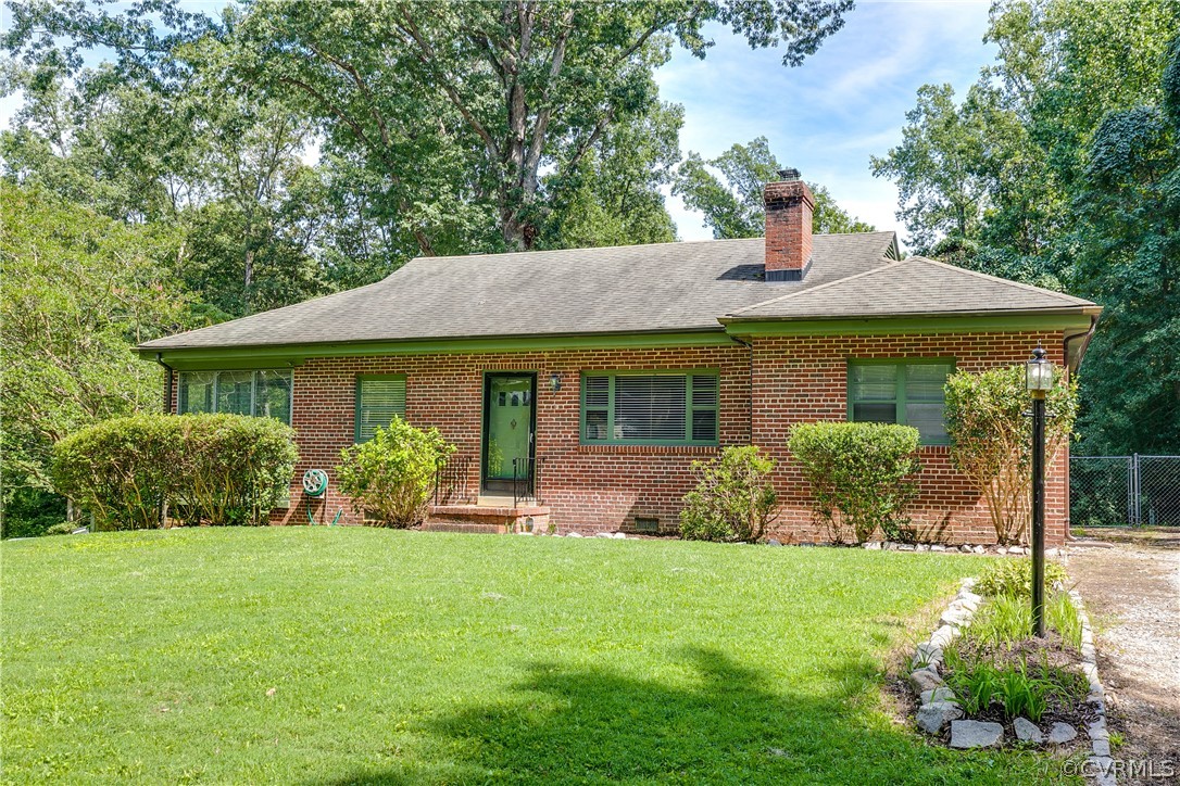 3911 Arklow Road Richmond, VA 23235 - Photo 3 of 39 a front view of a house with garden and porch
