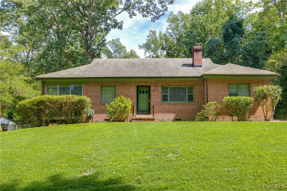 3911 Arklow Road Richmond, VA 23235 - Photo 4 of 39 a front view of a house with a yard and garage