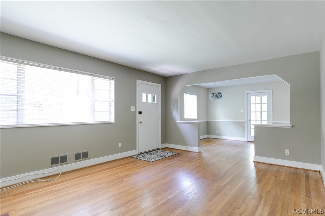 3911 Arklow Road Richmond, VA 23235 - Photo 8 of 39 an empty room with wooden floor and windows